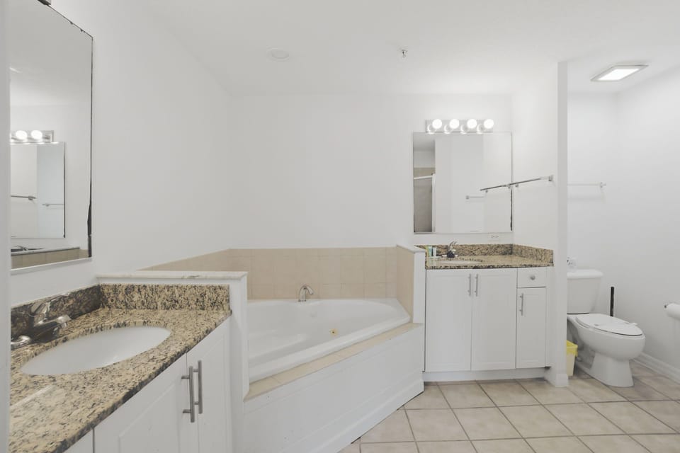 Large ensuite bathroom with dual vanities, soaking tub, and plenty of space to get ready.