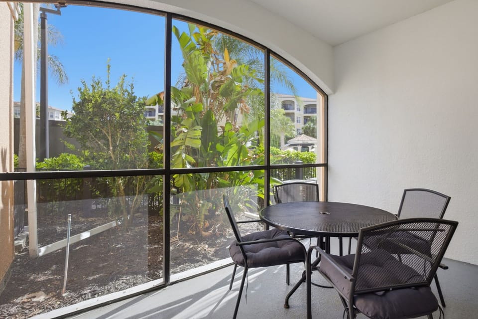 Private screened-in patio with seating—ideal for morning coffee or unwinding in the evening.