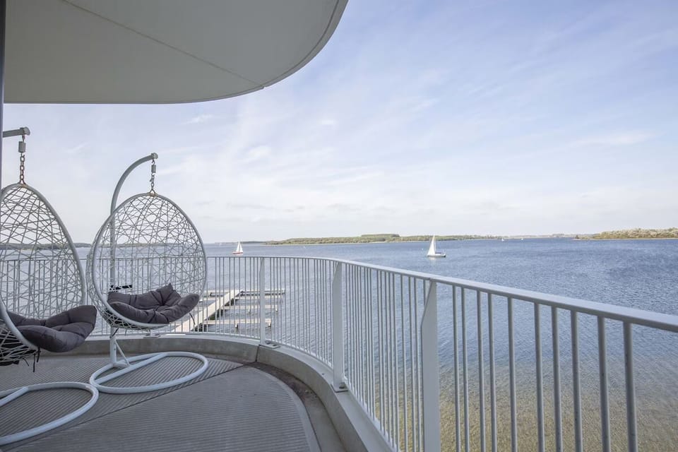 Unwind in hanging chairs while sailboats glide by.