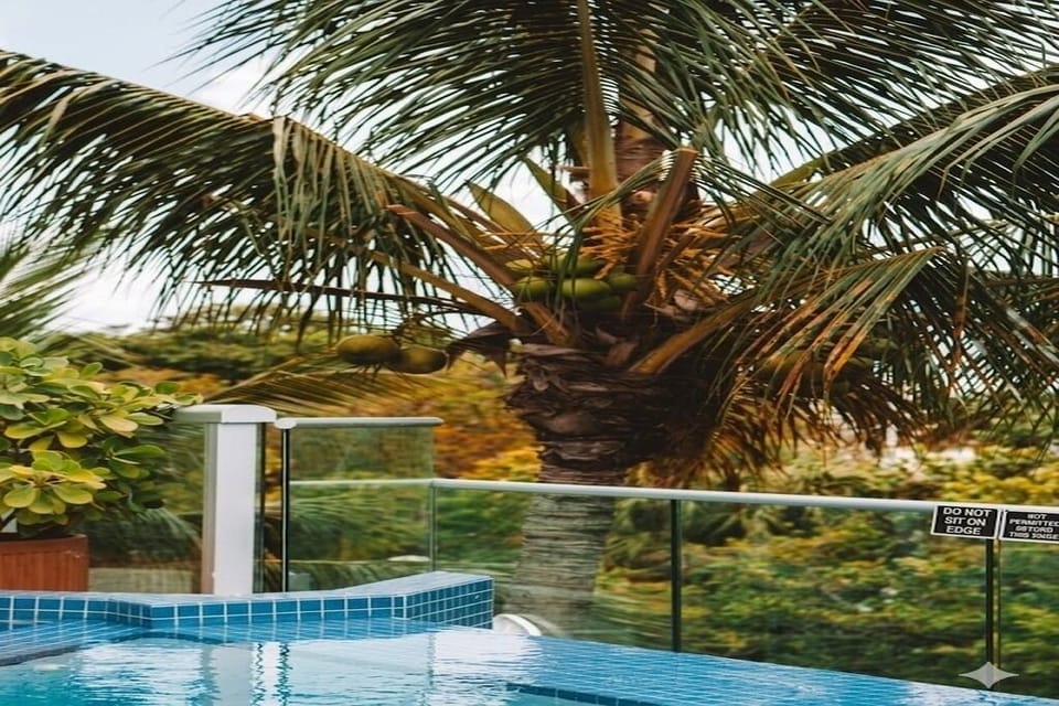 Linger poolside beneath swaying palms and warm island air.