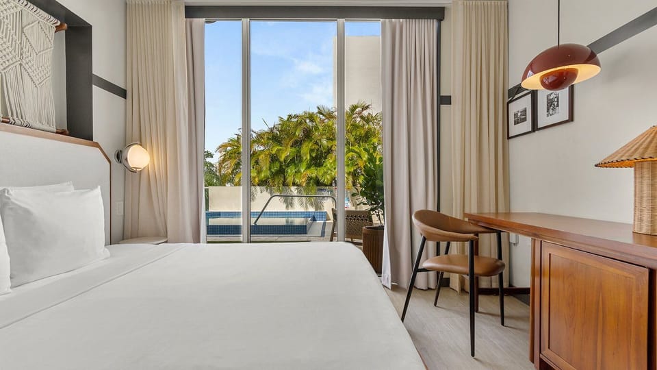 Sink into plush linens and step outside to tropical calm.