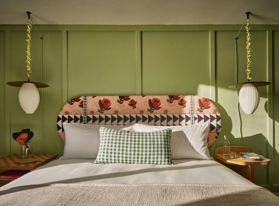 Drift off in a stylish, sunlit bed with plush linens.