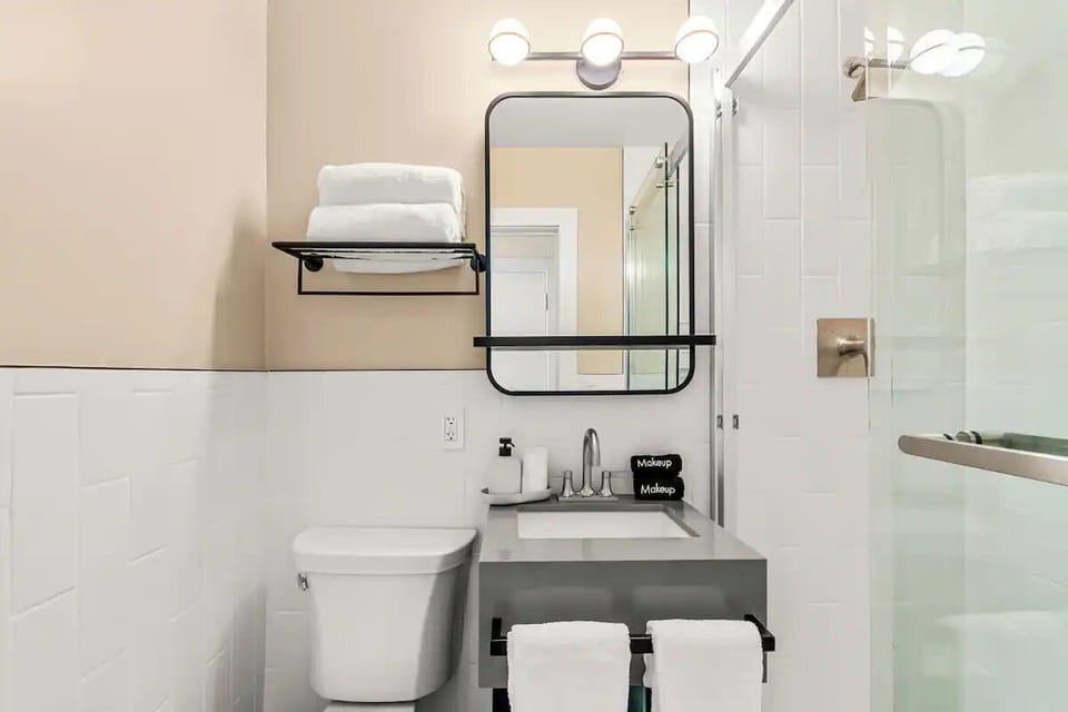 Refresh easily in a spotless, well-lit bathroom with fresh towels.