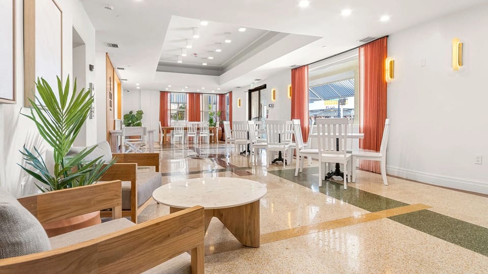 Relax with coffee in sunlit lounge seating and café tables.