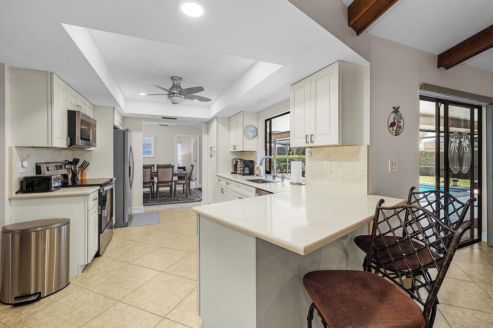 Kitchen area with breakfast bar and view of semi-formal dining room.