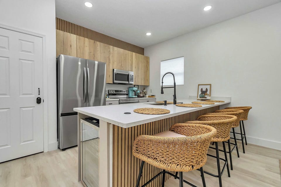 Modern kitchen w/ stainless appliances, sleek finishes & island seating for casual meals