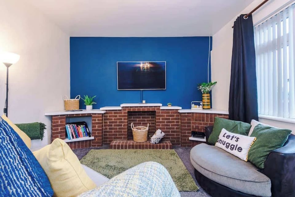 Cozy and vibrant living room with comfortable seating, natural light, and stylish decor, perfect for relaxation.