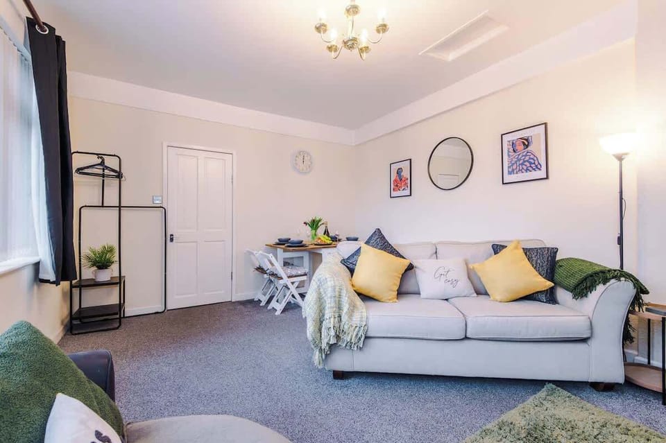 Cozy and vibrant living room with comfortable seating, natural light, and stylish decor, perfect for relaxation.