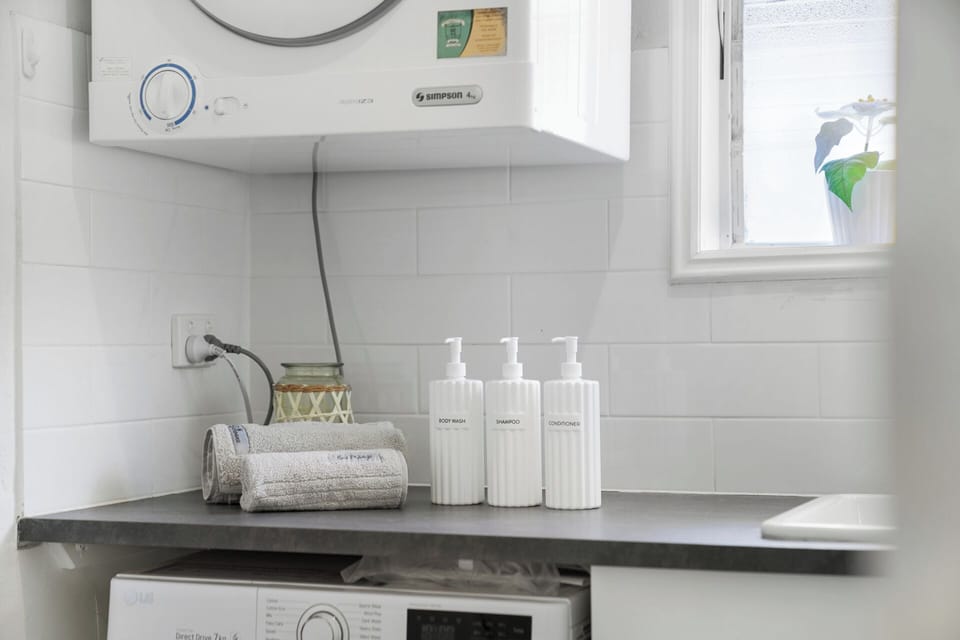 Bathroom/laundry combo with washer and dryer for your convenience; shower and toilet. 