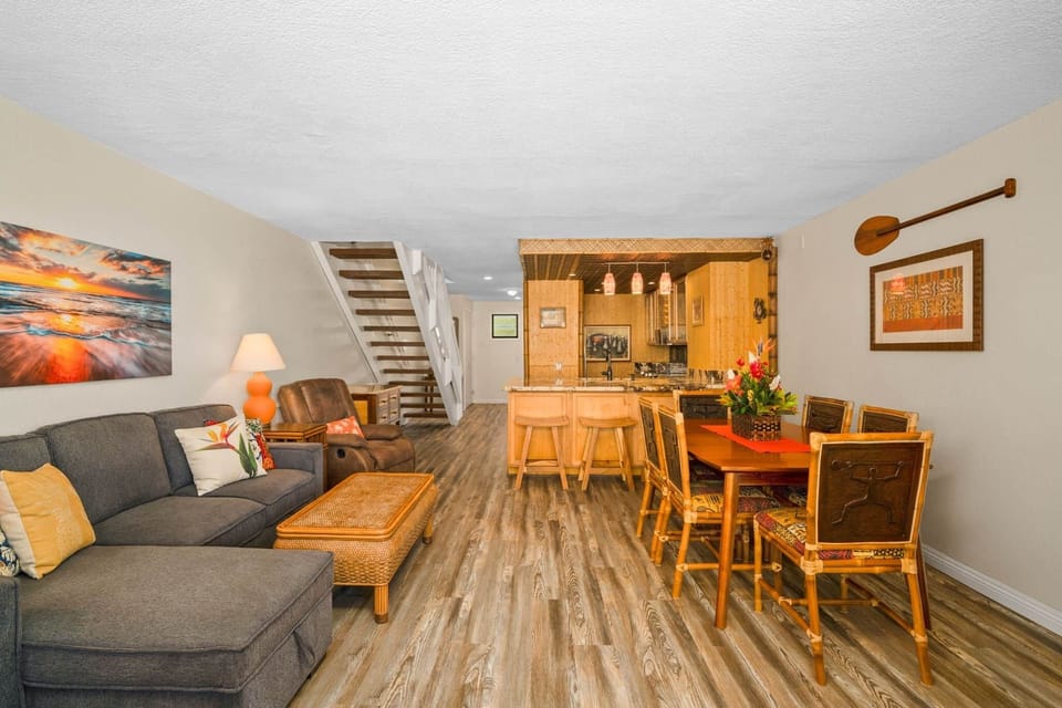 Relax, dine, and gather in this open living and dining space with tropical design, bamboo accents, a