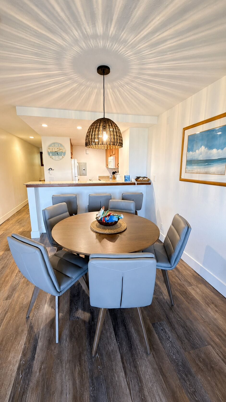 Dining table for four with pendant lighting and easy access to the kitchen and breakfast bar.