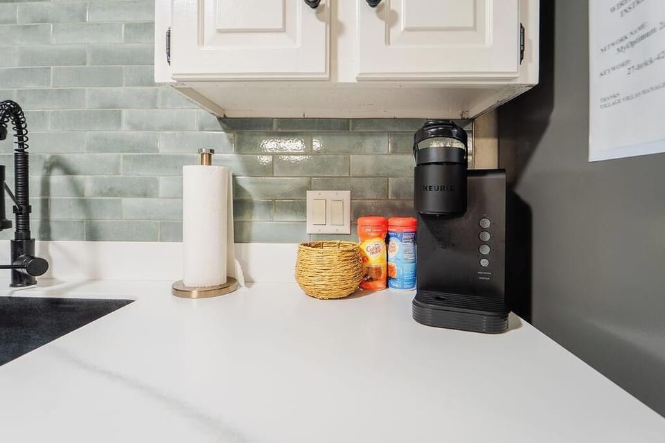 Keurig coffee maker with pods, creamers, and sugars provided 