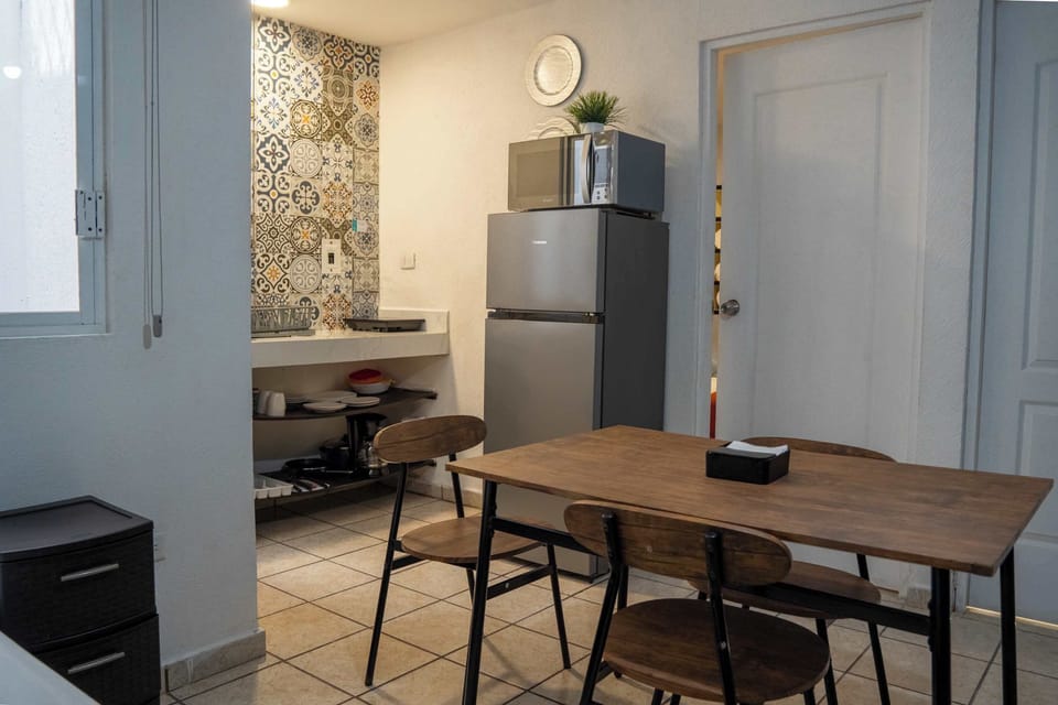 Bright dining area with patterned tile and seating for meals, a comfortable spot to gather