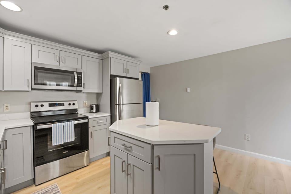 Full kitchen with island provides plenty of space for cooking and eating.