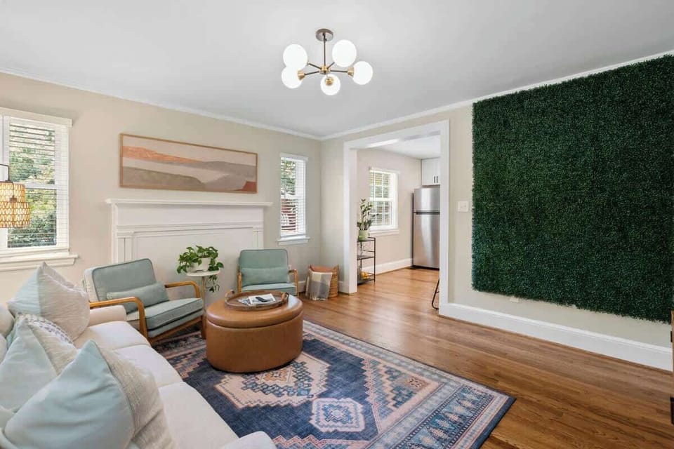 Bright, comfortable living room with plenty of seating and a 32 inch Roku TV and variety of board games available - perfect for relaxing after a day exploring Charlotte or enjoying a cozy night in.