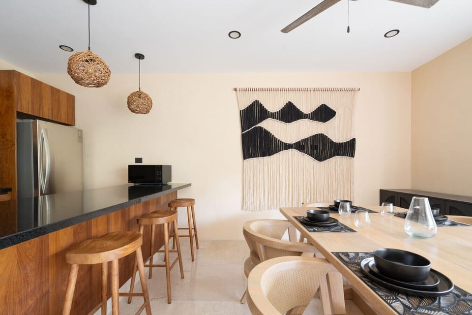 Modern dining with bar seating & warm wood accents ✨
