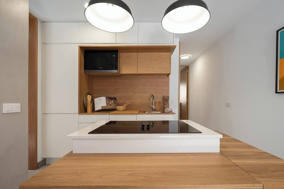 Fully equipped kitchen with oven, microwave, stove, and utensils