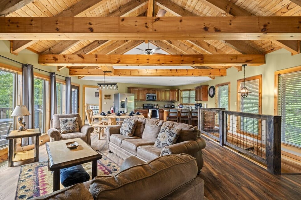 Admire the soaring exposed wood beams and expansive open floor plan, designed to maximize comfort while showcasing stunning Smoky Mountain views.