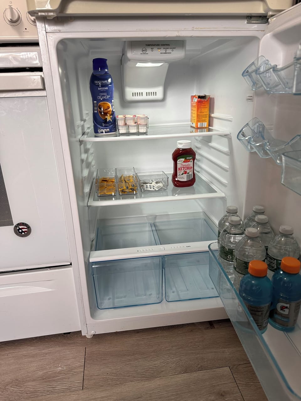 Stocked fridge with creamer, ketchup, mayo and mustard, water bottles & Gatorade
