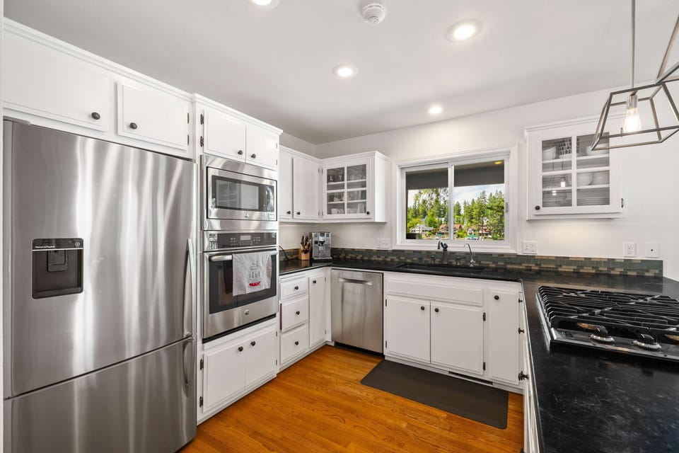 Well appointed kitchen with stainless steel appliances and gas cookstove