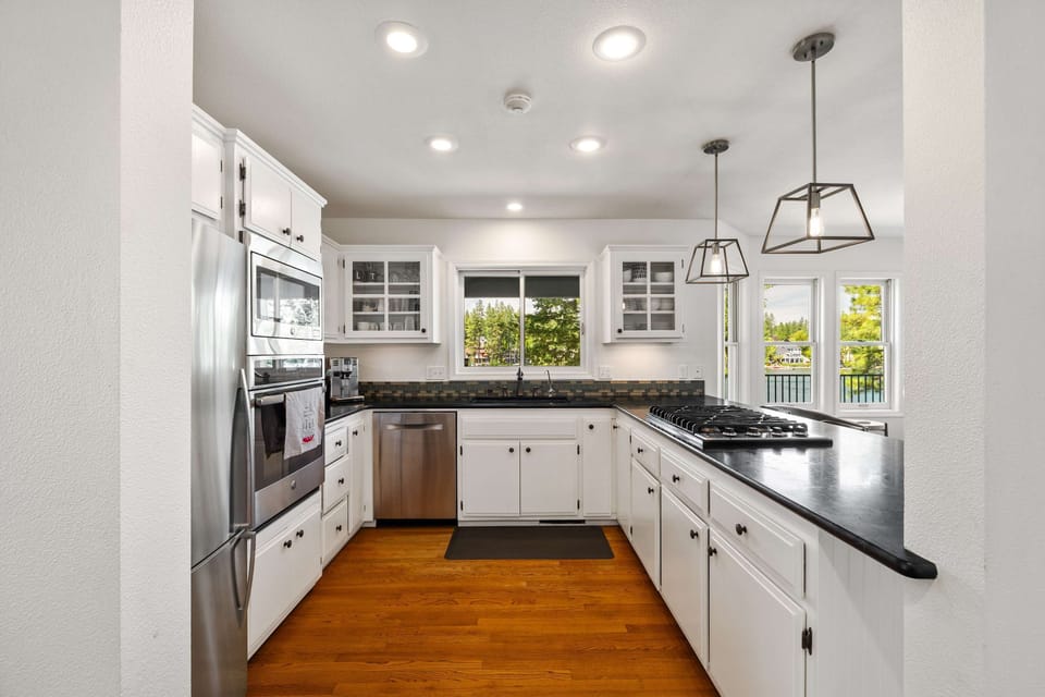 Well appointed kitchen with stainless steel appliances and gas cookstove