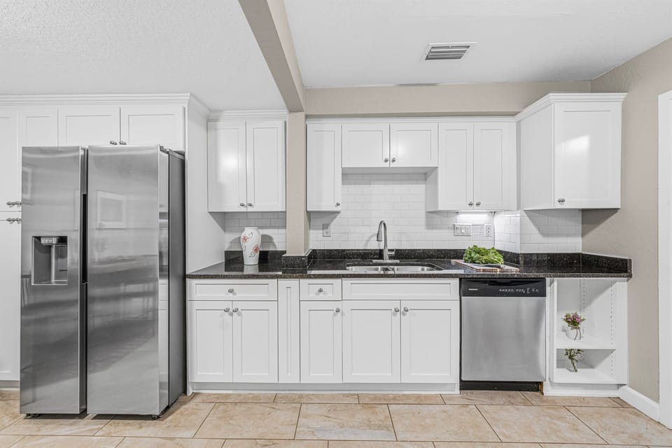 Modern kitchen featuring stainless steel appliances, sleek cabinetry, and ample counter space for cooking.