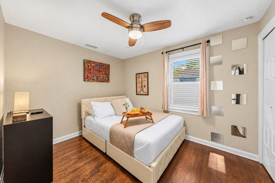 Stylish bedroom with plush bedding, modern décor, and warm natural lighting.
