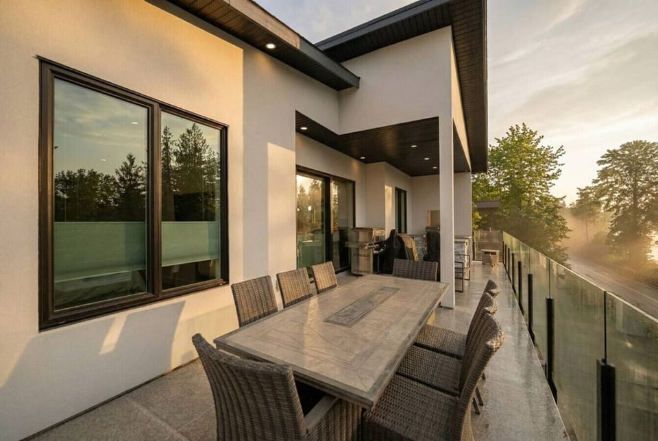 Private balcony with an outdoor kitchen, dining area and lake views.