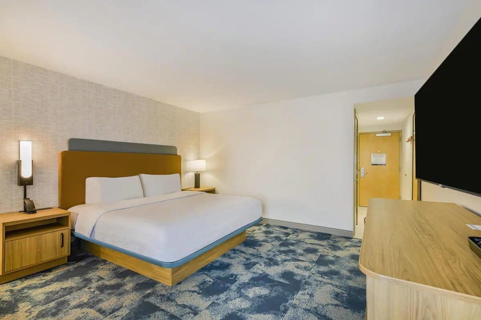 Unwind in a bright king bedroom with plush bedding