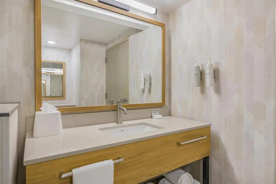 Get ready easily at the wide vanity and glowing mirror