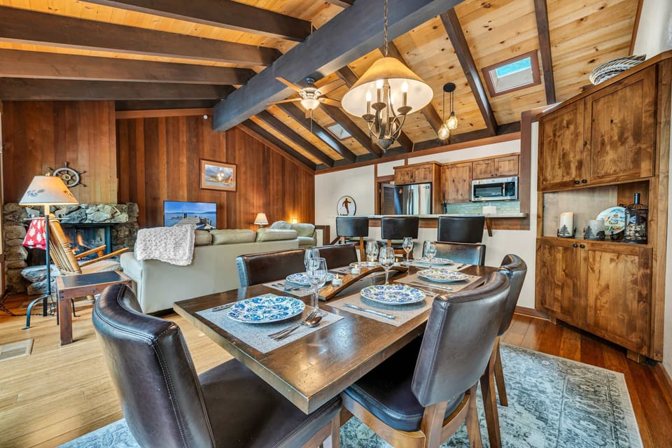 Dining area with seating for 6 at the table and 3 additional seats at the kitchen bar.