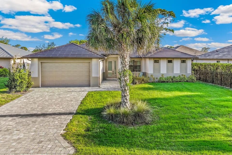 Inviting Florida vacation rental with private driveway, garage, and landscaped yard