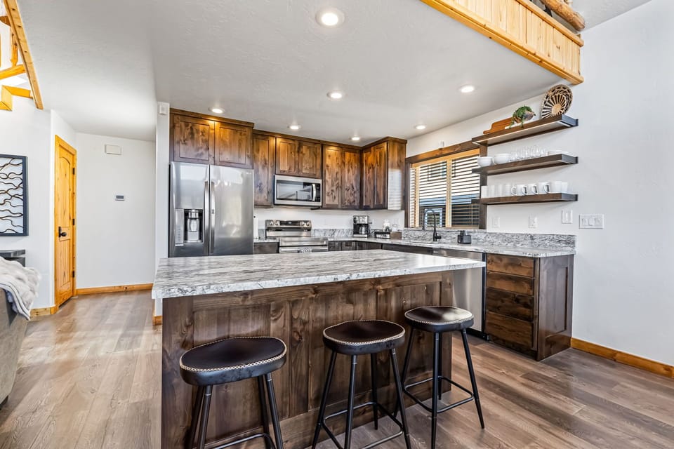 Fully updated kitchen with island seating—perfect for gathering and meals.