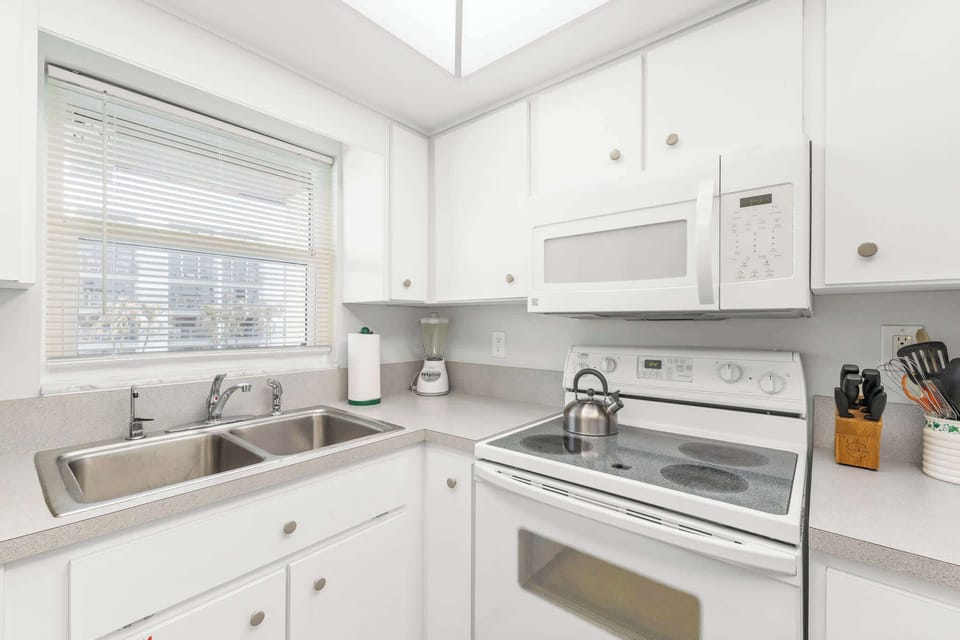 Kitchen with White Cabinets, Sink, and Window
