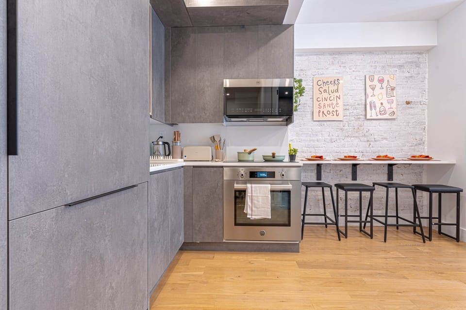 Modern kitchen with breakfast bar seating and stylish design.