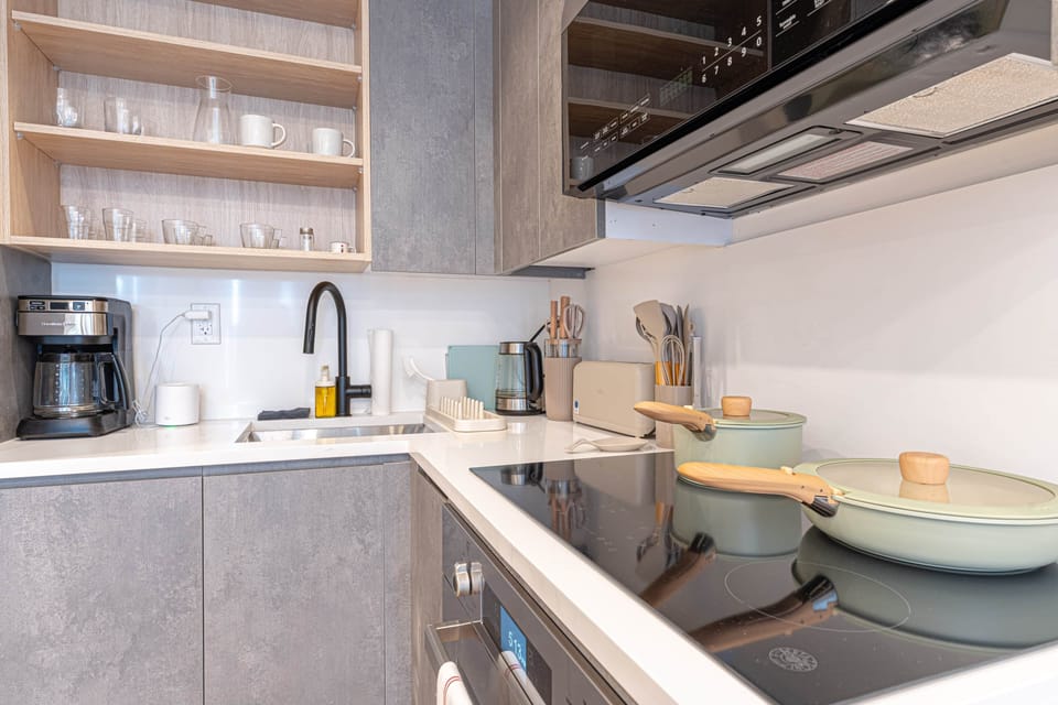 Modern kitchen with cooktop, coffee maker, and fully equipped setup