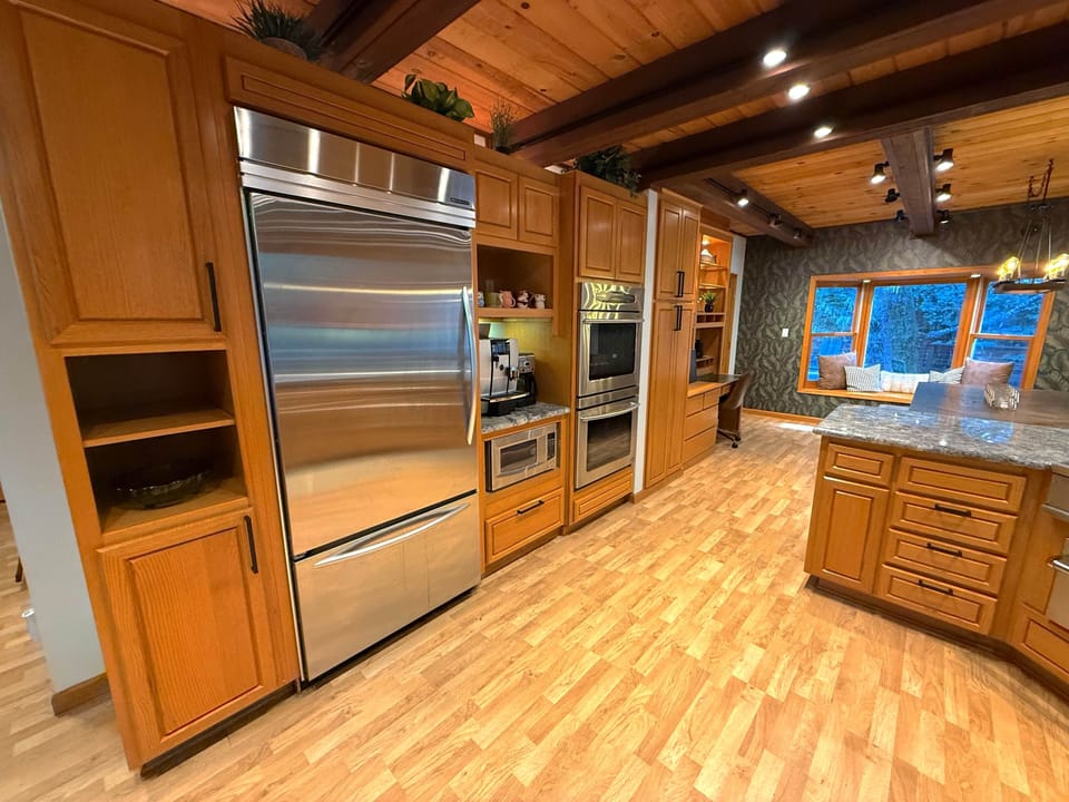 Commercial size refrigerator, double ovens, microwave, espresso and coffee machines, desk/working ar
