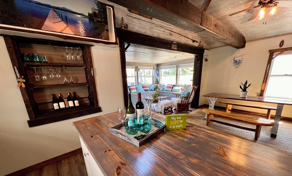 Kitchen island with view of wine rack, dining room, & back porch