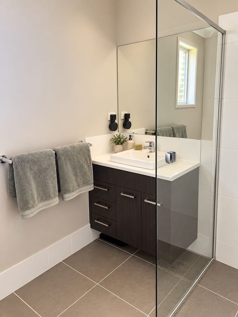 Modern bathroom with glass shower and sleek vanity