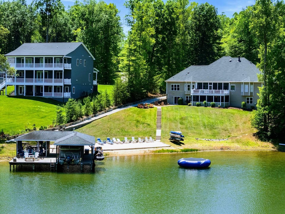 Lakefront - The covered boathouse, anchored water trampoline, and a row of shoreline chairs line this quiet Lake Anna cove.