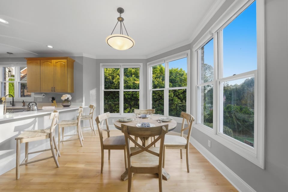 Cozy dining nook with bay‑window views of the surrounding greenery.