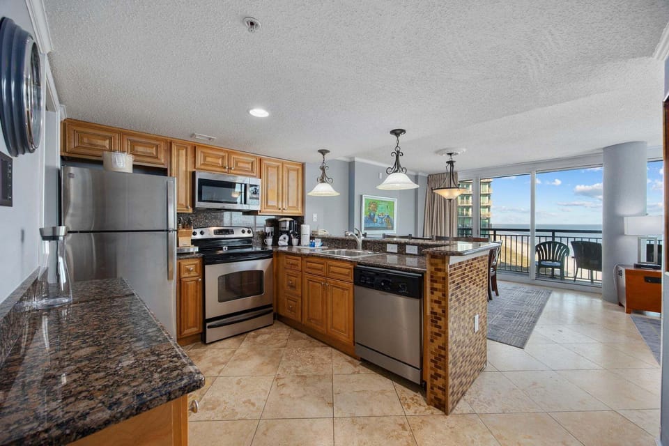 The open kitchen layout allows you to stay connected with others while preparing dinner.