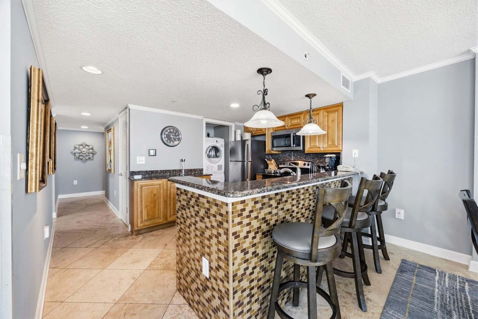 The kitchen island provides a central spot to gather for coffee or a quick bite before heading out.
