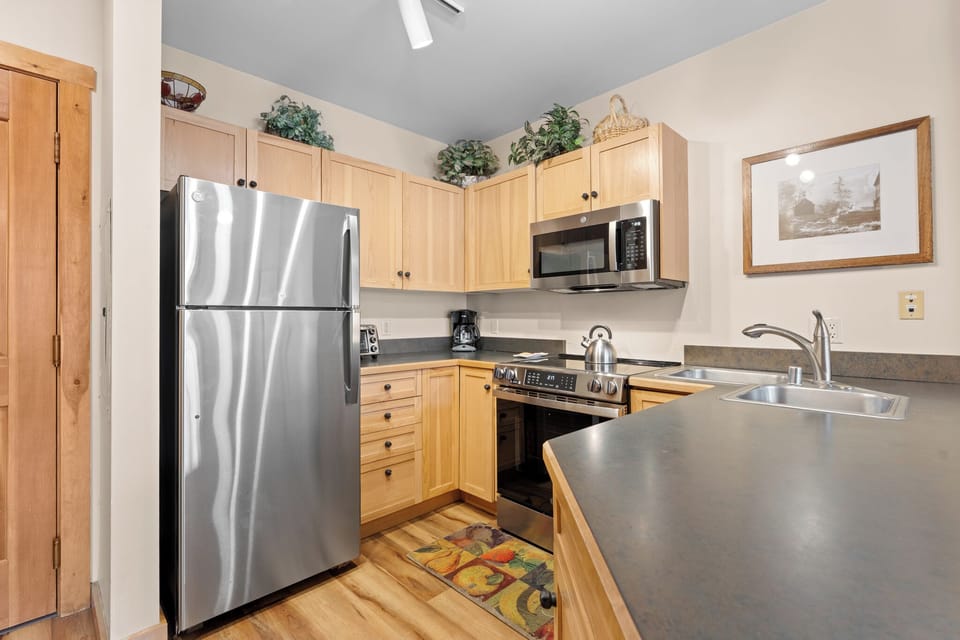 Full kitchen with stainless steel appliances.