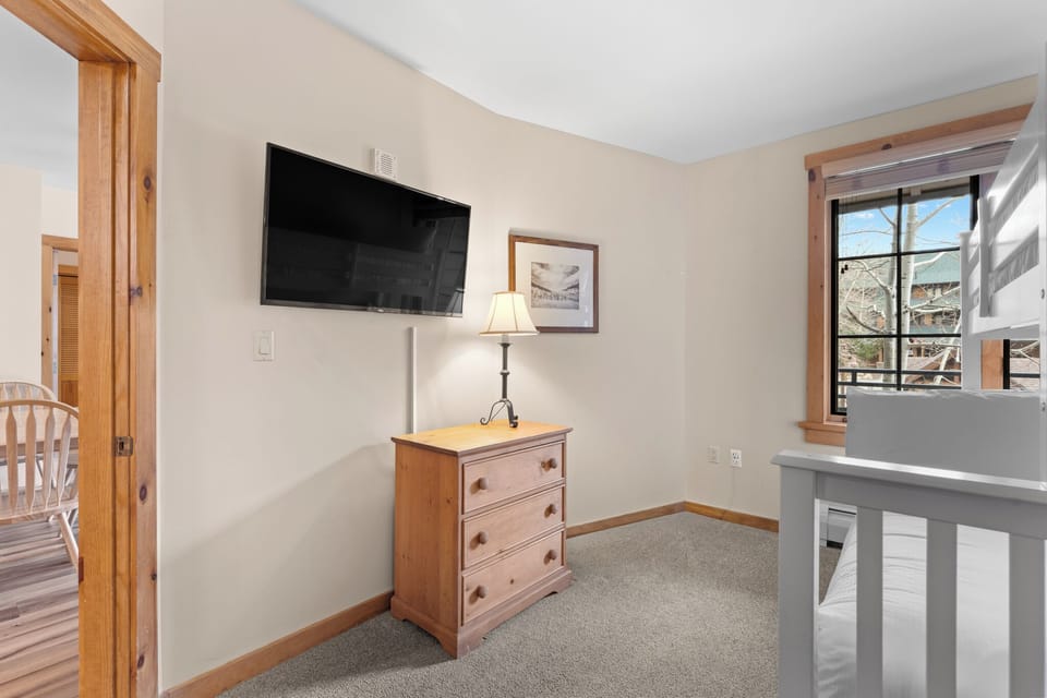 The guest bedroom offers a twin over full bunk bed with twin trundle, and mounted TV.
