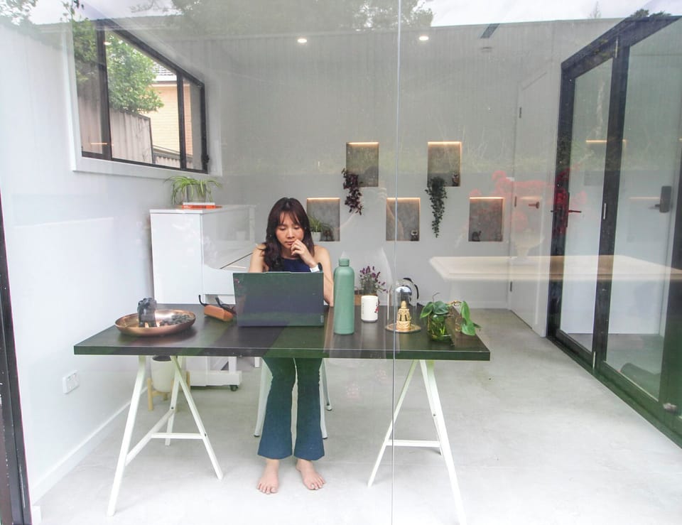 Dedicated workspace with natural light and sliding door access to the backyard.