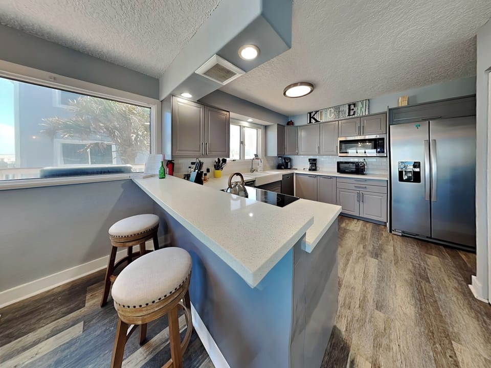Fully Equipped Kitchen + Breakfast Bar Seating for 2