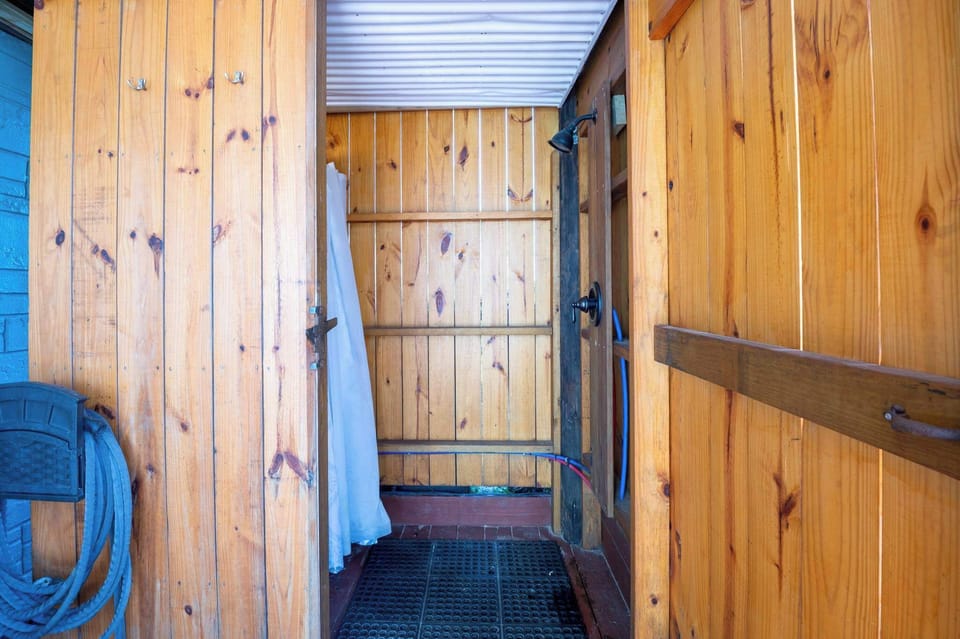 Enclosed outside  shower with hot water