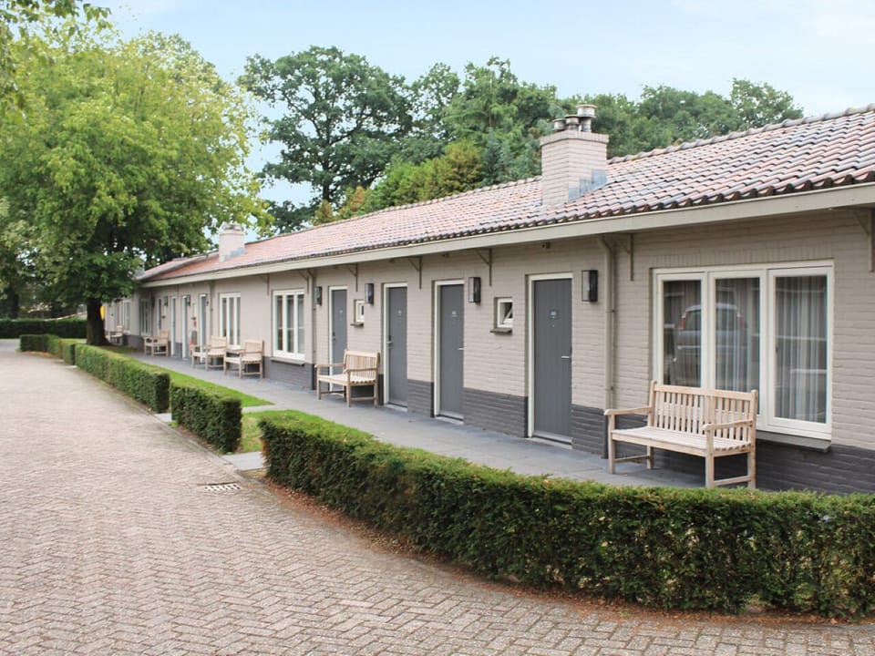 Arrive to a peaceful row of rooms with benches.