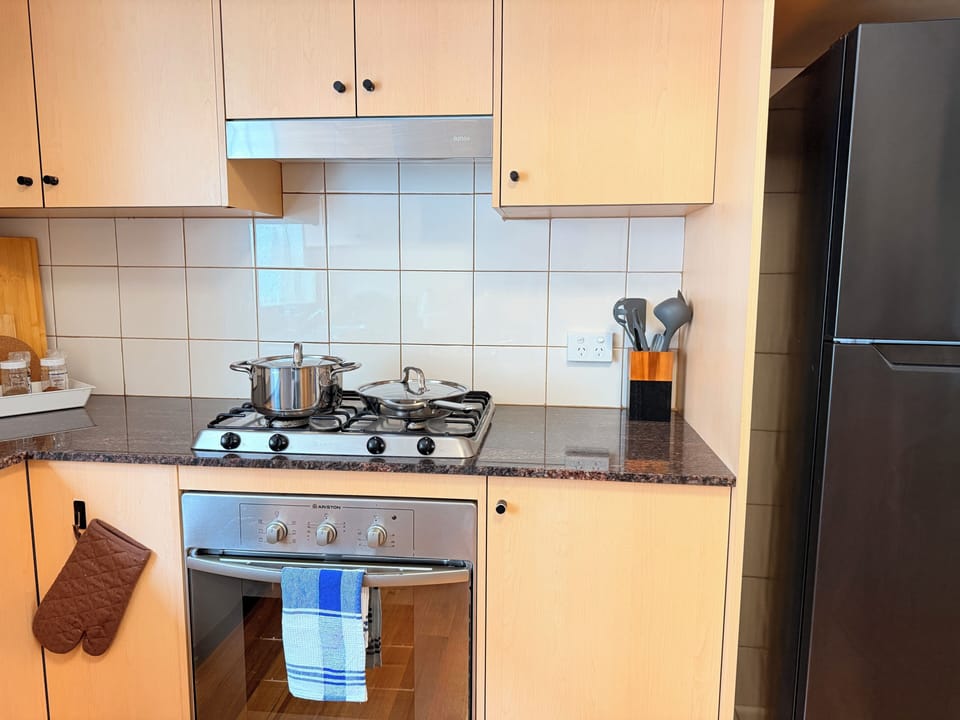 4-burner stove with oven, cookware, pots, and essentials for easy cooking.